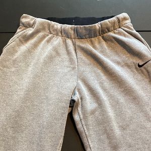 Nike Dri-fit sweatpants with pockets and tapered legs with zippers